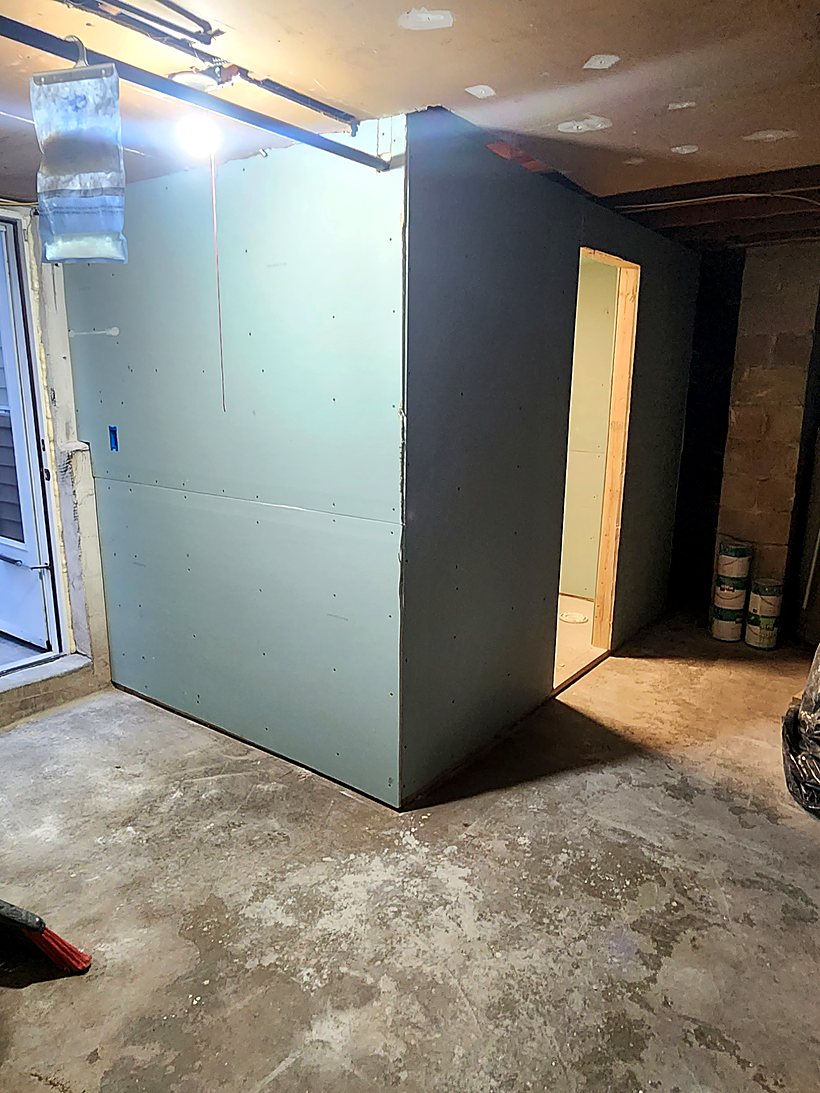 Basement bathroom enclosure framed and boarded, ready for waterproofing and tile