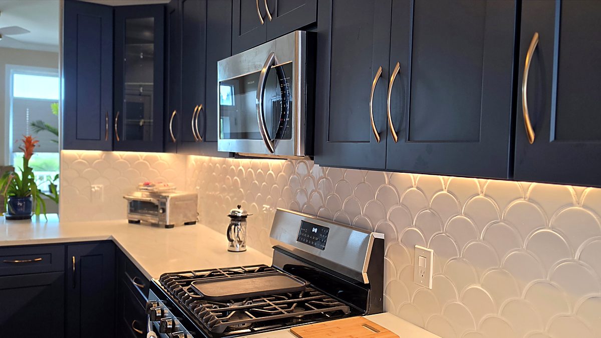 Finished kitchen remodel with navy shaker cabinets and a scalloped tile backsplash in Fairfield County, CT