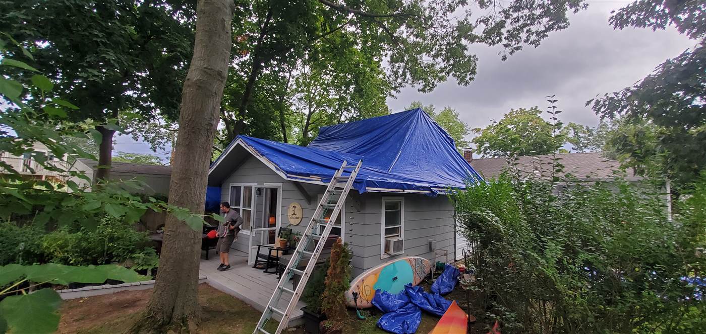 Roof protected with a tarp during storm-damage repair work in Fairfield County, CT