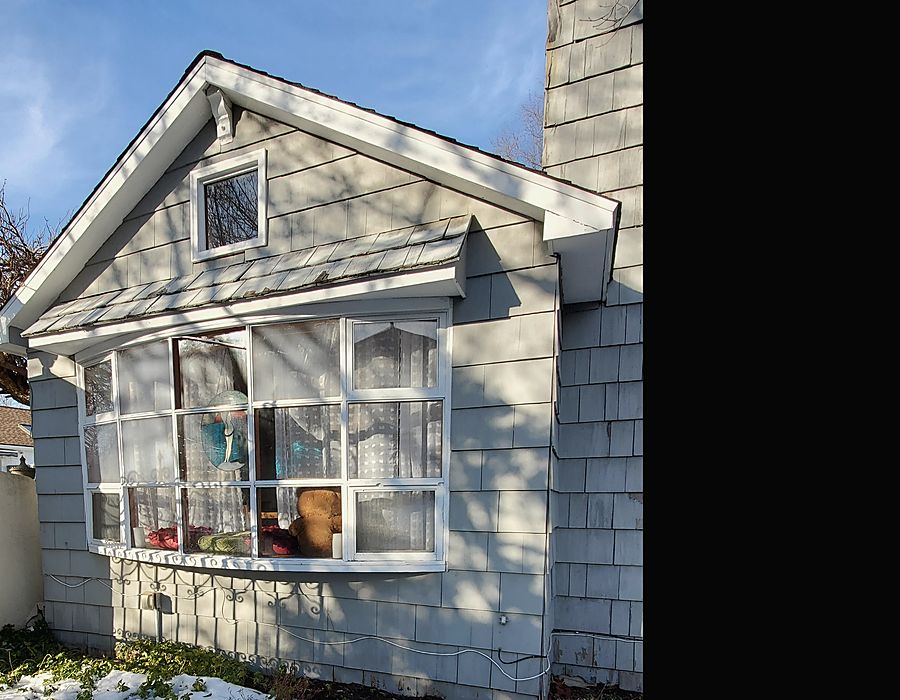 Old bow window with failing frames and small panes on a Fairfield County, CT home before replacement